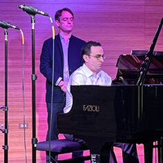 Patrick Zimmeli observes rehearsals as Ian Gindes performs at the piano.